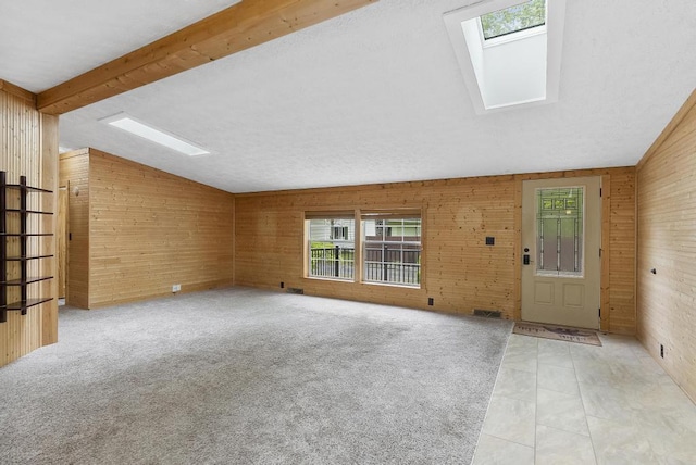 1505 Shawnee Dr, Indian River, MI 49749 - unfurnished living room featuring a skylight and wood walls