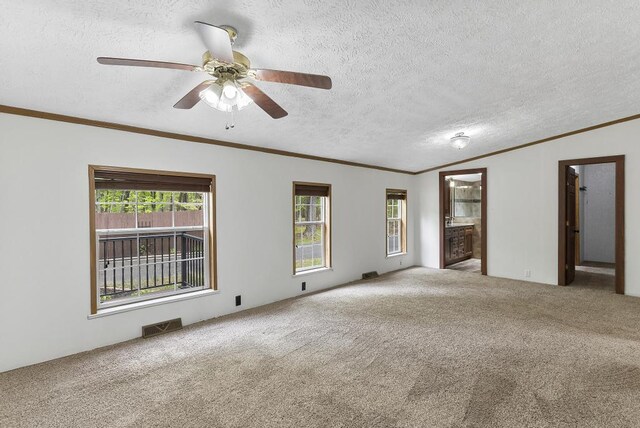 1505 Shawnee Dr, Indian River, MI 49749 - carpeted empty room featuring a textured ceiling, ornamental molding, and ceiling fan