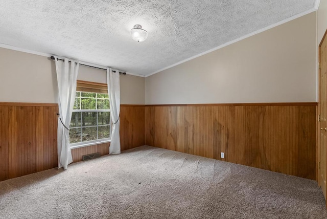 1505 Shawnee Dr, Indian River, MI 49749 - carpeted spare room featuring wooden walls, a wainscoted wall, a textured ceiling, and crown molding