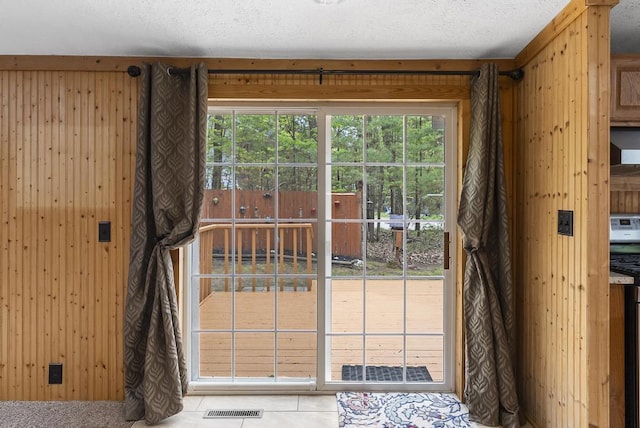 1505 Shawnee Dr, Indian River, MI 49749 - doorway to outside with wood walls and a textured ceiling