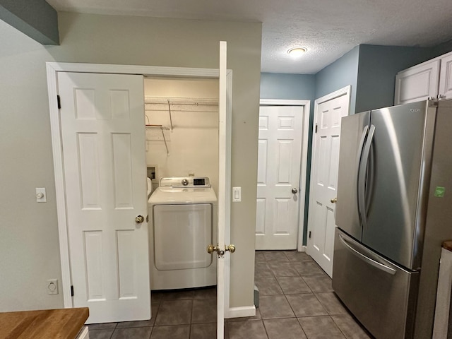 1243 Euclid Ave, Grayling, MI 49738 - clothes washing area featuring washer / dryer, dark tile patterned flooring, and a textured ceiling