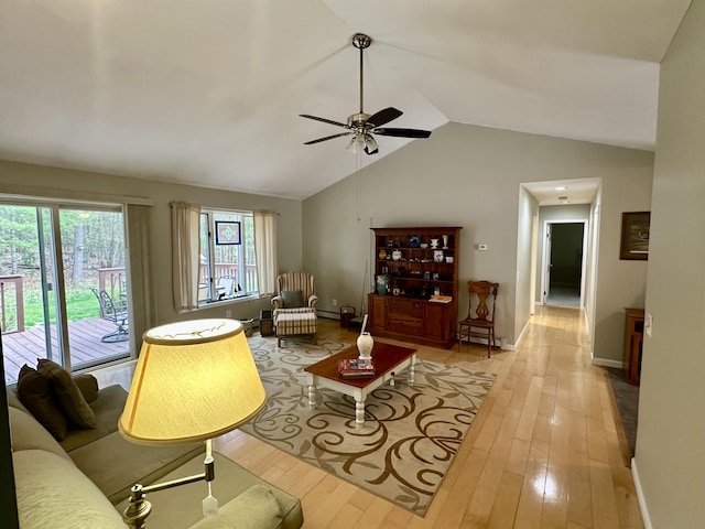 1243 Euclid Ave, Grayling, MI 49738 - living room featuring vaulted ceiling, a ceiling fan, wood-type flooring, and baseboards