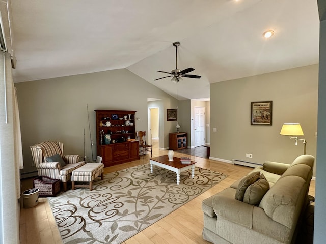 1243 Euclid Ave, Grayling, MI 49738 - living area featuring a baseboard radiator, wood finished floors, a ceiling fan, lofted ceiling, and baseboards