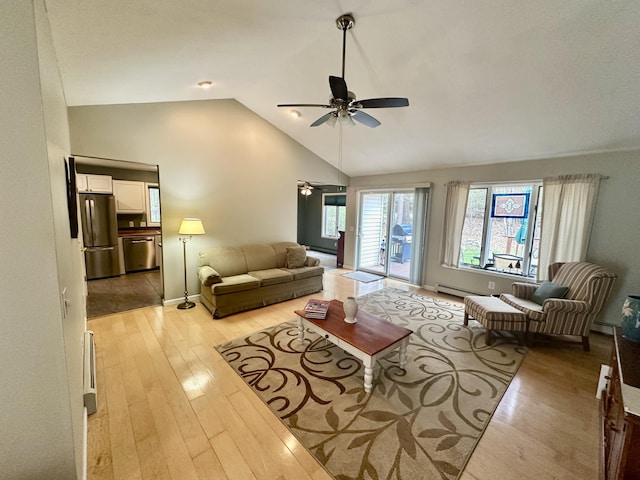 1243 Euclid Ave, Grayling, MI 49738 - living room with a ceiling fan, light wood-style flooring, vaulted ceiling, a baseboard radiator, and baseboards