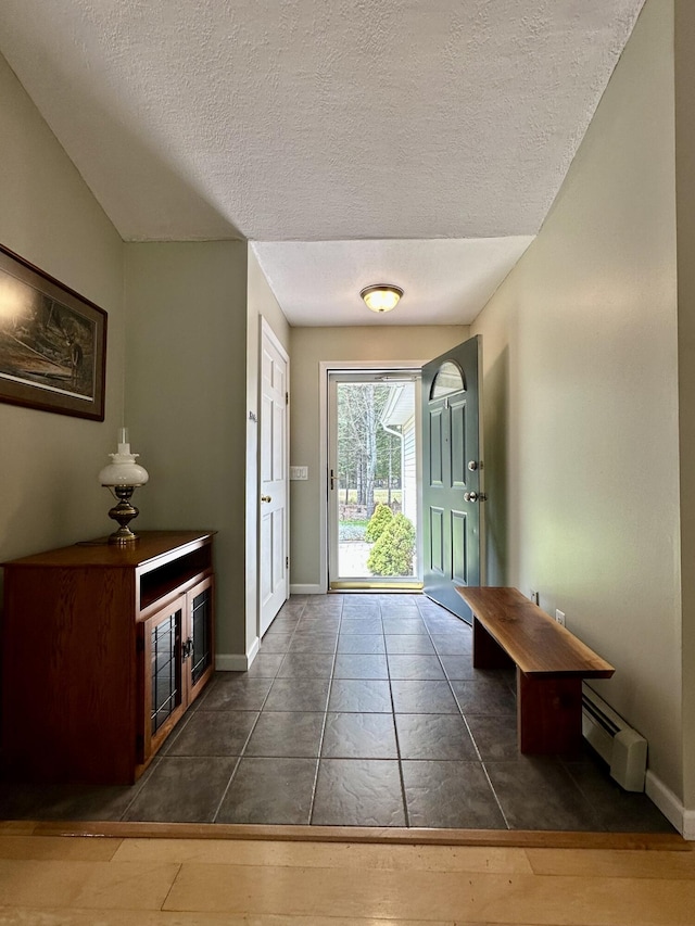 1243 Euclid Ave, Grayling, MI 49738 - entrance foyer with a baseboard heating unit, baseboards, a textured ceiling, and tile patterned flooring