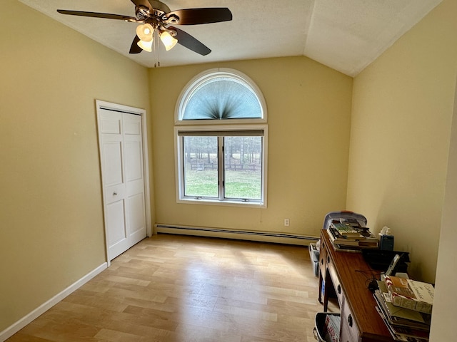 1243 Euclid Ave, Grayling, MI 49738 - empty room featuring baseboard heating, lofted ceiling, light wood finished floors, ceiling fan, and baseboards