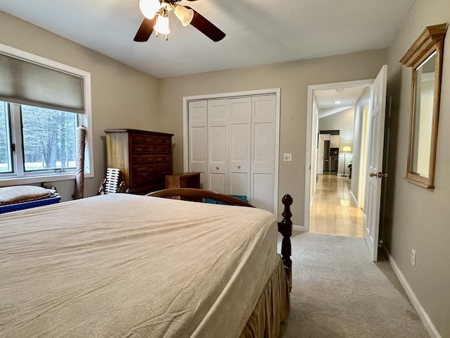 1243 Euclid Ave, Grayling, MI 49738 - bedroom featuring baseboards, light carpet, ceiling fan, and a closet