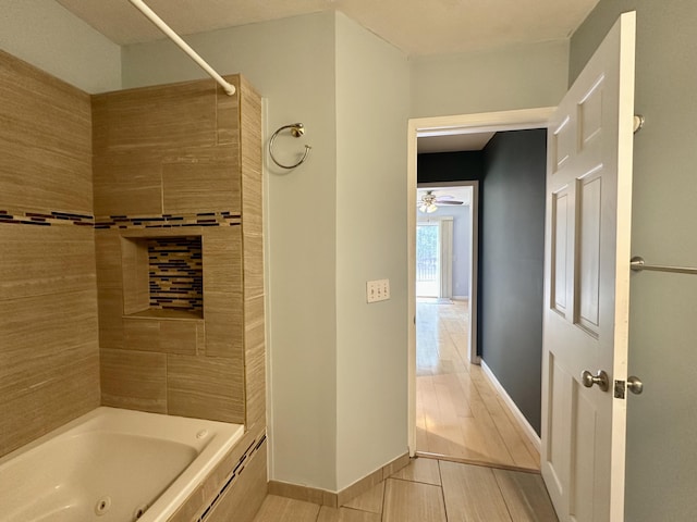 1243 Euclid Ave, Grayling, MI 49738 - bathroom with baseboards, tub / shower combination, and a ceiling fan