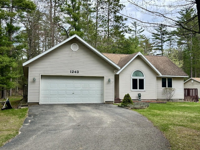 1243 Euclid Ave, Grayling, MI 49738 - single story home featuring driveway, roof with shingles, an attached garage, and a front yard