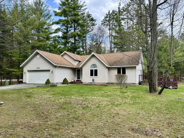1243 Euclid Ave, Grayling, MI 49738 - ranch-style house featuring an attached garage, asphalt driveway, a front yard, and a shingled roof