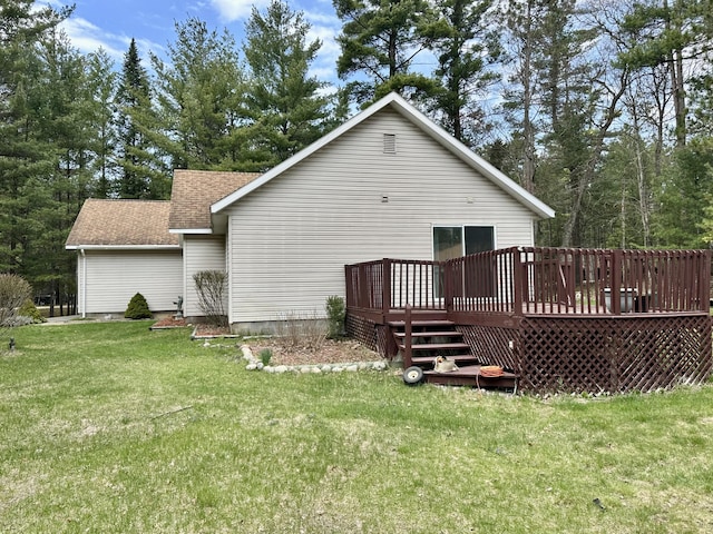 1243 Euclid Ave, Grayling, MI 49738 - back of property featuring roof with shingles, a deck, and a lawn