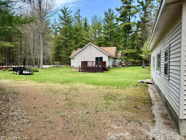 1243 Euclid Ave, Grayling, MI 49738 - view of grassy yard featuring a wooden deck