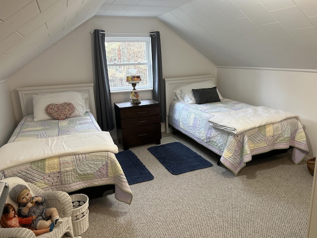 bedroom with carpet floors and vaulted ceiling