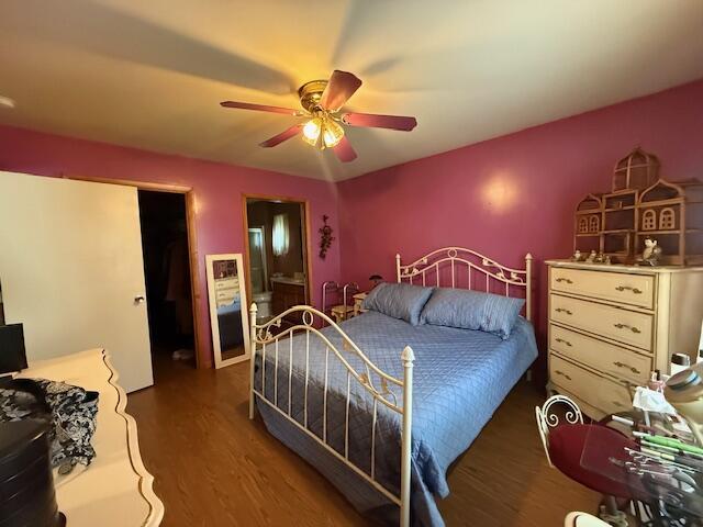 206 Great Oak Dr, Roscommon, MI 48653 - bedroom with wood finished floors, a ceiling fan, and ensuite bath