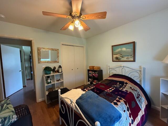 206 Great Oak Dr, Roscommon, MI 48653 - bedroom featuring wood finished floors, a closet, ceiling fan, and baseboards