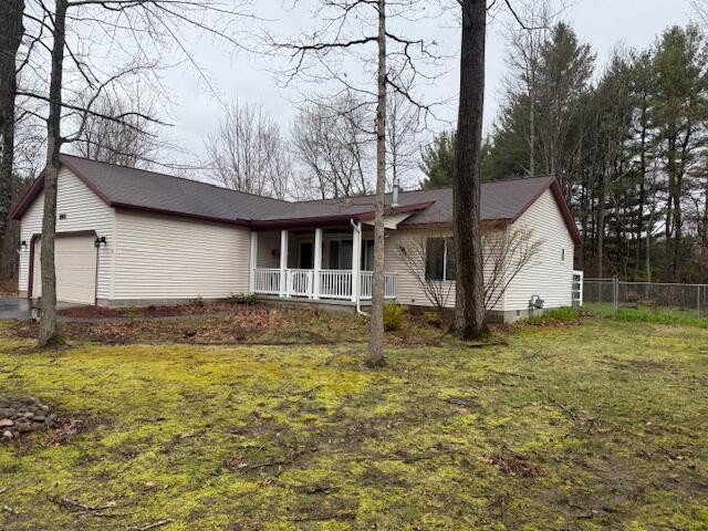 206 Great Oak Dr, Roscommon, MI 48653 - ranch-style house featuring covered porch, crawl space, and a garage