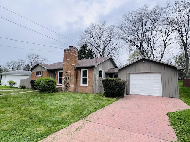 single story home with a garage, decorative driveway, a front yard, and a chimney