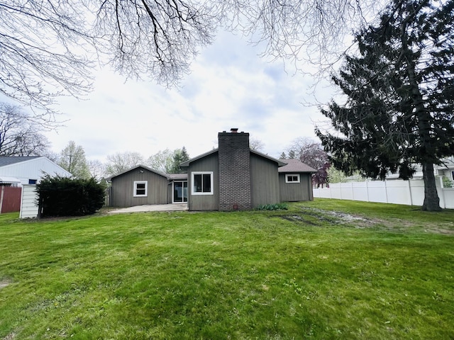 back of house with a chimney and a patio