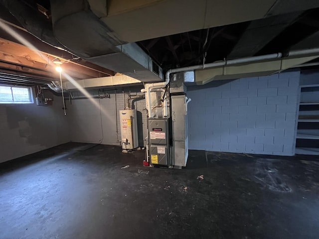below grade area featuring water heater and heating unit