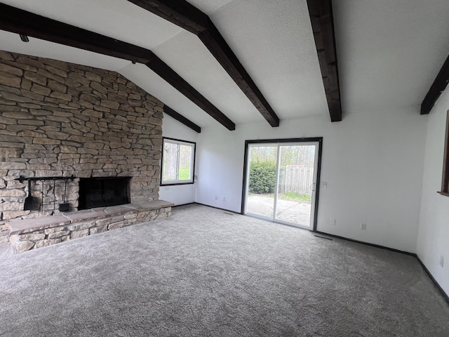 unfurnished living room with carpet, baseboards, and a stone fireplace