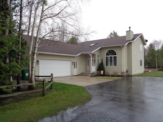 single story home featuring asphalt driveway, a chimney, a garage, and a shingled roof