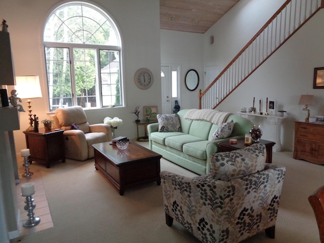 living area with light colored carpet and stairway
