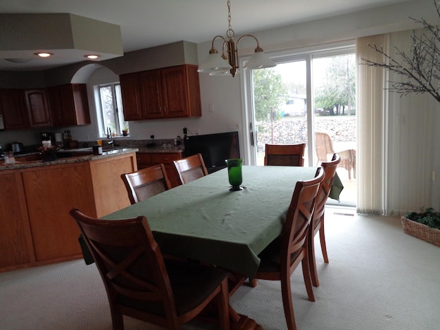dining space featuring light carpet, healthy amount of natural light, a chandelier, and recessed lighting