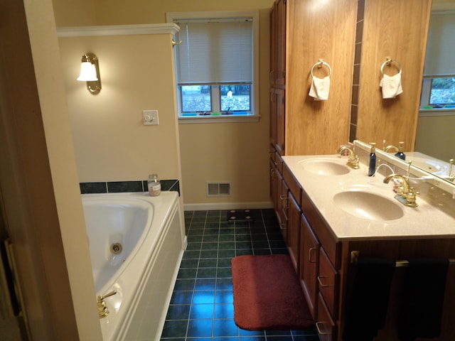 full bathroom featuring tile patterned flooring, a tub with jets, double vanity, and baseboards