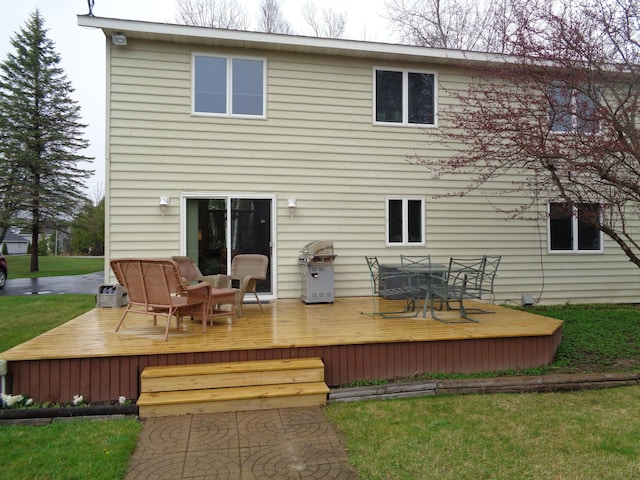 back of house with a deck, a lawn, and outdoor dining space