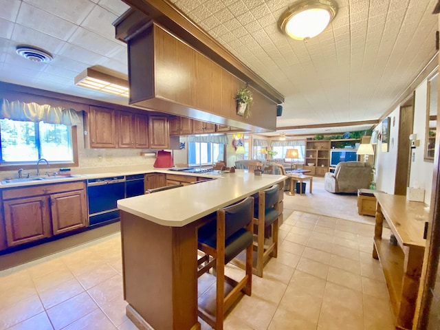 10328 Toohy Trl, Harrison, MI 48625 - kitchen featuring dishwashing machine, a sink, open floor plan, light countertops, and a peninsula