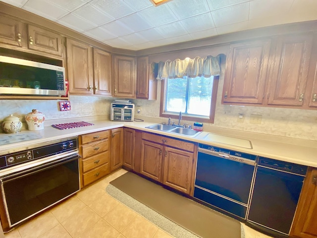 10328 Toohy Trl, Harrison, MI 48625 - kitchen with dishwasher, a sink, oven, stainless steel microwave, and light countertops