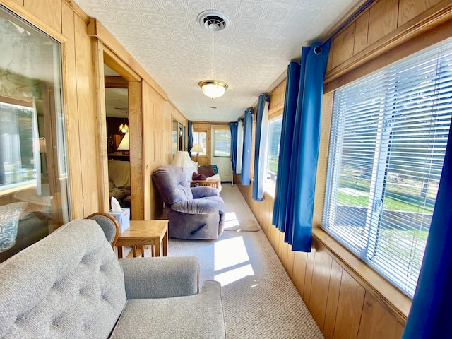 10328 Toohy Trl, Harrison, MI 48625 - sunroom featuring wooden walls, an ornate ceiling, and carpet flooring