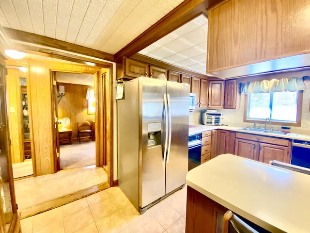 10328 Toohy Trl, Harrison, MI 48625 - kitchen featuring stainless steel refrigerator with ice dispenser, a sink, wood walls, black oven, and light countertops