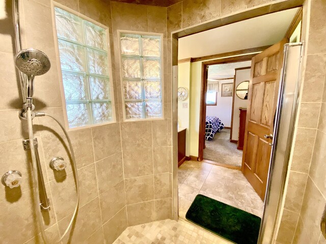 10328 Toohy Trl, Harrison, MI 48625 - bathroom with tiled shower, ensuite bathroom, and tile patterned floors