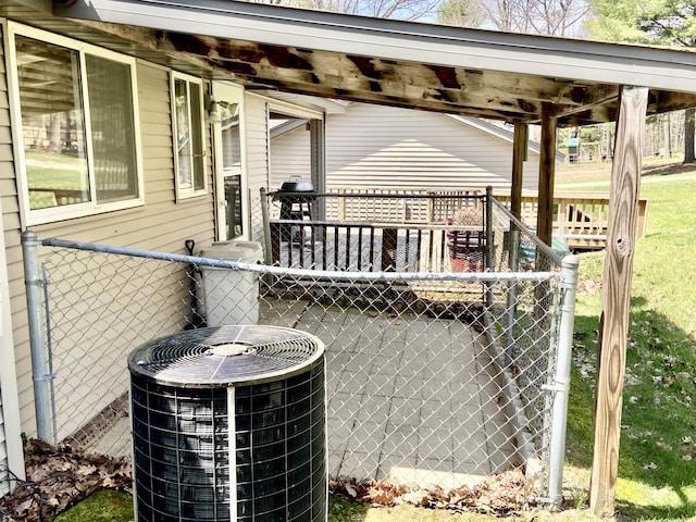 10328 Toohy Trl, Harrison, MI 48625 - wooden deck featuring central AC and fence