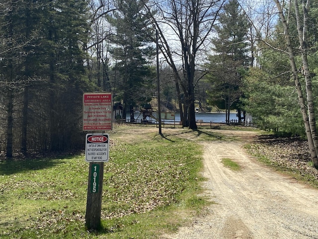 10328 Toohy Trl, Harrison, MI 48625 - view of street with a water view and a wooded view