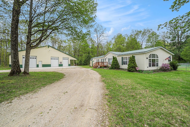 8978 Starvation Lake Rd, Mancelona, MI 49659 - view of side of home featuring driveway, a garage, a lawn, and an outdoor structure