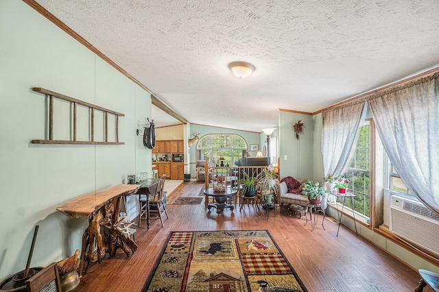 8978 Starvation Lake Rd, Mancelona, MI 49659 - living room with ornamental molding, wood finished floors, a textured ceiling, and vaulted ceiling