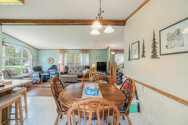 8978 Starvation Lake Rd, Mancelona, MI 49659 - dining space featuring a chandelier, healthy amount of natural light, vaulted ceiling, and crown molding