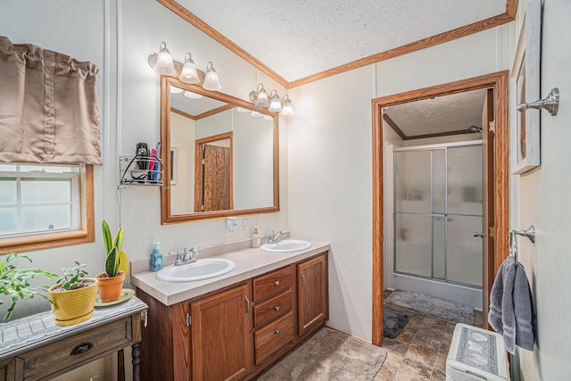 8978 Starvation Lake Rd, Mancelona, MI 49659 - full bath featuring crown molding, a textured ceiling, a stall shower, double vanity, and stone finish flooring