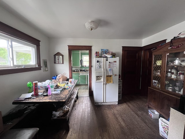 dining area with dark wood-style flooring and plenty of natural light
