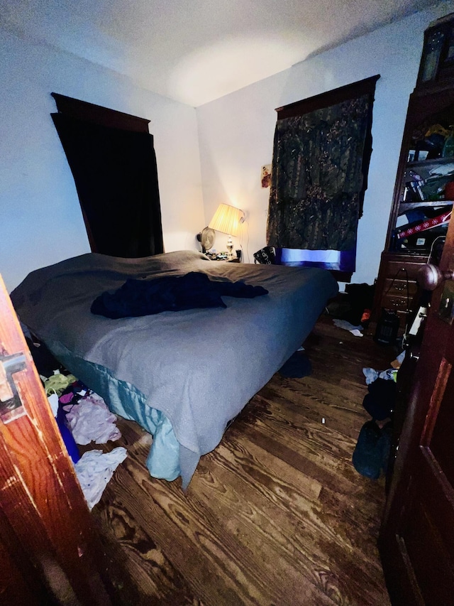 bedroom featuring wood finished floors and a textured ceiling