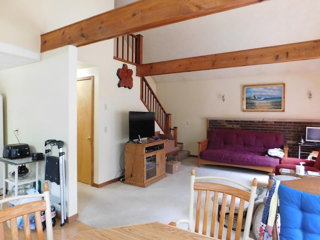 8727 S Oak Rd, Grayling, MI 49738 - living area featuring light colored carpet, beamed ceiling, and stairs