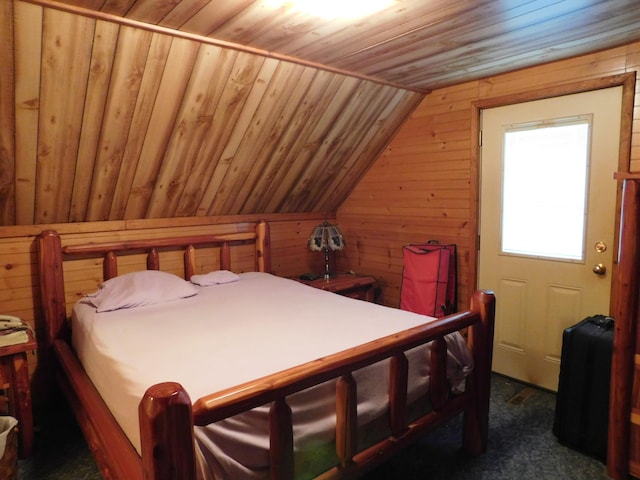 8727 S Oak Rd, Grayling, MI 49738 - bedroom featuring wood ceiling, vaulted ceiling, dark carpet, and wood walls