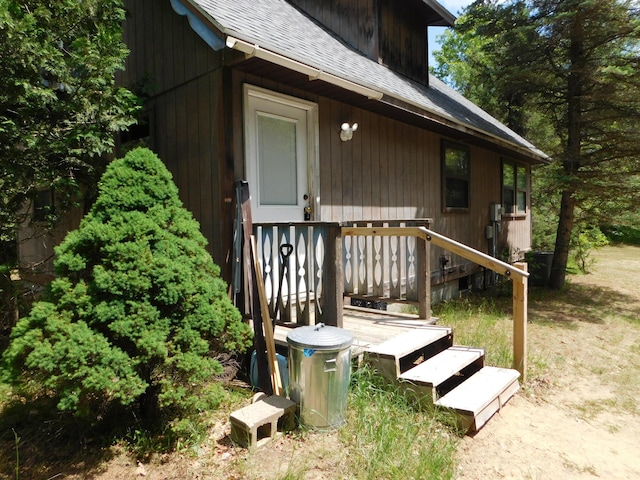 8727 S Oak Rd, Grayling, MI 49738 - property entrance featuring a shingled roof