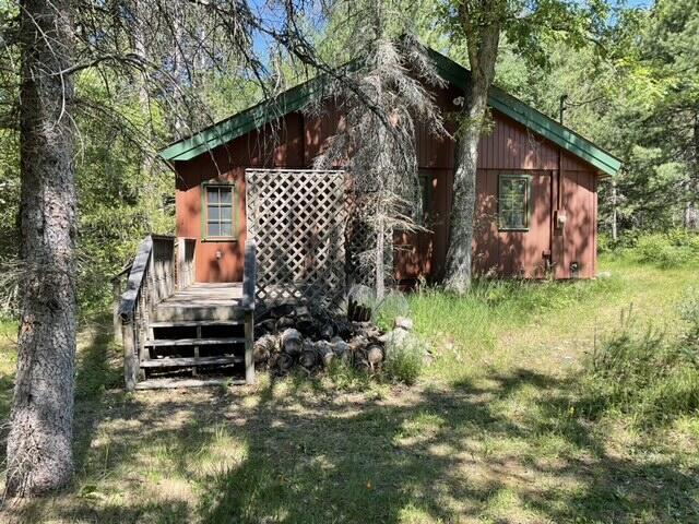 8842 Jackson Hole Trl, Grayling, MI 49738 - view of side of home with a deck and a forest view
