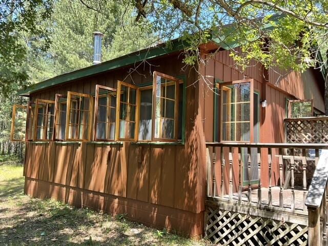8842 Jackson Hole Trl, Grayling, MI 49738 - view of side of home featuring a deck