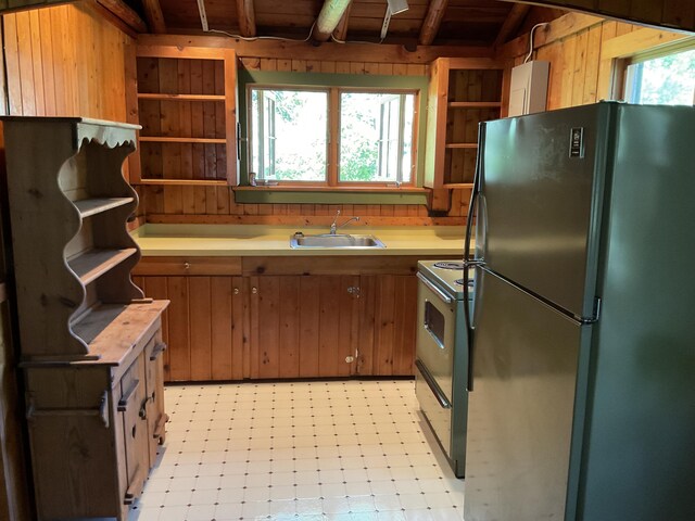 8842 Jackson Hole Trl, Grayling, MI 49738 - kitchen with open shelves, freestanding refrigerator, range with electric stovetop, a sink, and light countertops