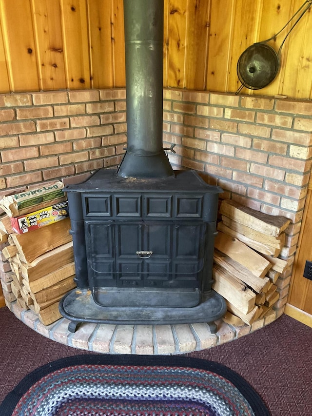 8842 Jackson Hole Trl, Grayling, MI 49738 - detailed view of a wood stove, carpet floors, and baseboards