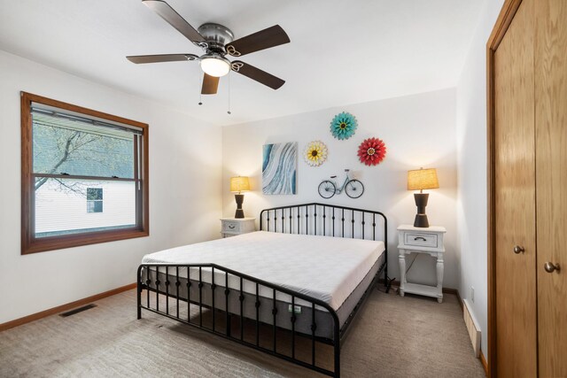 301 Hugh St, East Jordan, MI 49727 - carpeted bedroom featuring a closet, baseboards, and ceiling fan